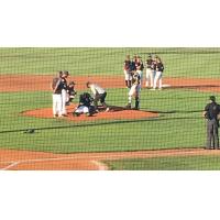Salem-Keizer Volcanoes RHP Gregory Santos lays on the mound after getting hit by a batted ball