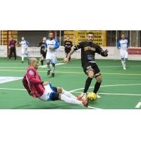 Juan Pereira of the Baltimore Blast (right) fights through a Utica City tackle attempt