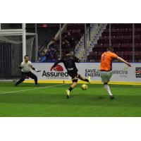 Jon Orlando of the Baltimore Blast (right) shoots vs. the Mississauga Metrostars