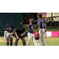 Frisco RoughRiders converse while the umpire examines his pants