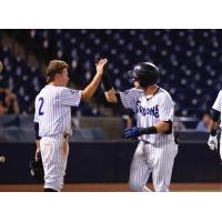 Diego Castillo (left) gives Donny Sands a high five following Sands' home run for the Tampa Tarpons