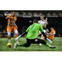 Nick Perera of the Tacoma Stars slides a goal past Florida Tropics goalkeeper Hugo Silva