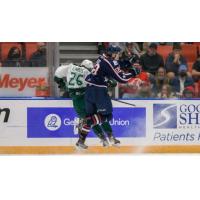 Tri-City Americans center Samuel Huo delivers a blow against the Everett Silvertips