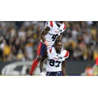 Montreal Alouettes receivers Quan Bray (top) and Eugene Lewis celebrate after a score