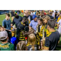 Albert Dikwa of the Pittsburgh Riverhounds signing autographs