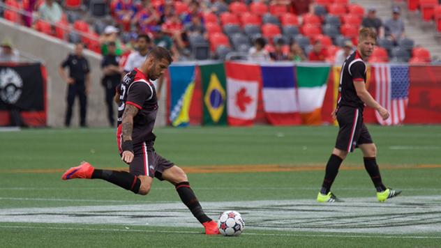 Rafael Alves, kicking, and Richie Ryan of Ottawa Fury FC