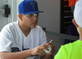 Julio Urias of the Tulsa Drillers Signs for a Fan