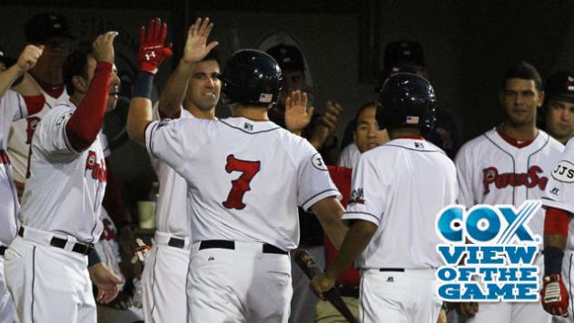 Garin Cecchini of the Pawtucket Red Sox Congratulated in the Dugout