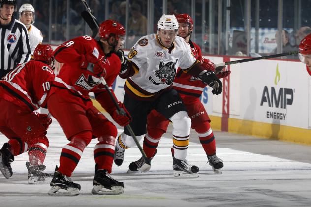 Yannick Veilleux of the Chicago Wolves Fights Through a Crowd of Charlotte Checkers