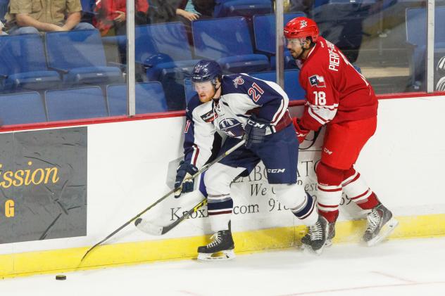 Kevin Pyle of the Tulsa Oilers Fends off Casey Pierro-Zabotel of the Allen Americans