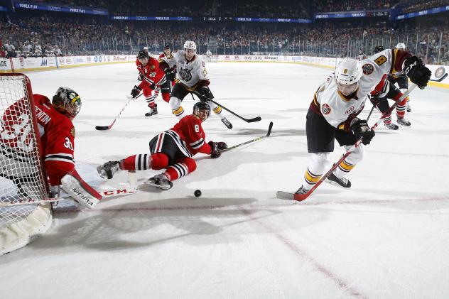 Ty Rattie of the Chicago Wolves Chases the Puck vs. the Rockford IceHogs