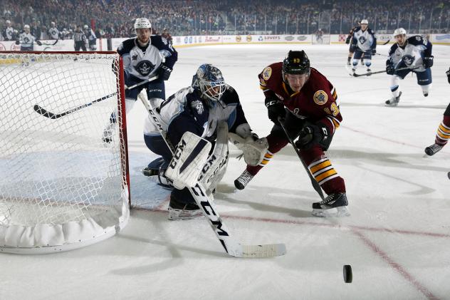Chicago Wolves F Evan Trupp Eyes a Loose Puck vs. the Milwaukee Admirals
