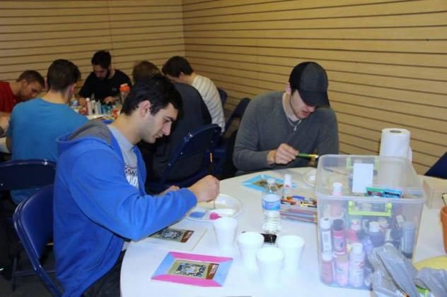 Spiro Goulakos and Matt Prapavessis work on their paintings