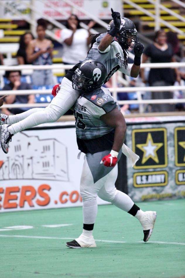 Wondell Rutledge of the Duke City Gladiators Lifts Dello Davis after a Davis Touchdown