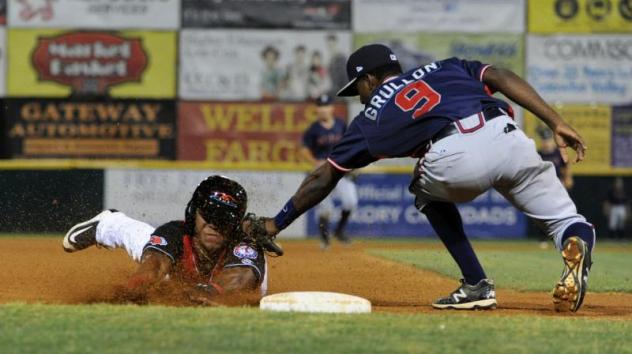 Deivi Grullon of the Greensboro Grasshoppers Tags out a Hickory Crawdads Baserunner