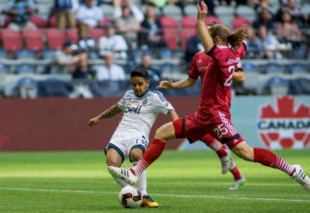 Lance Rozeboom of Ottawa Fury FC Challenges Christian Techera of the Vancouver Whitecaps