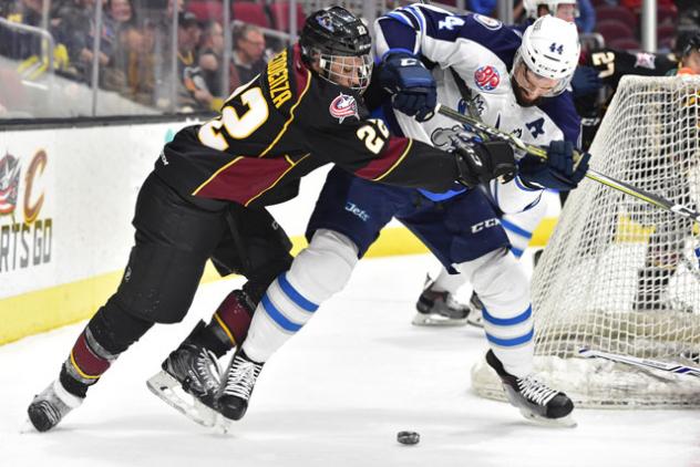 Cleveland Monsters Fight for the Puck vs. the Manitoba Moose