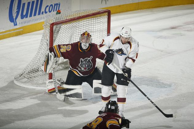 Cleveland Monsters Try to Score on Chicago Wolves Goaltender Oscar Dansk