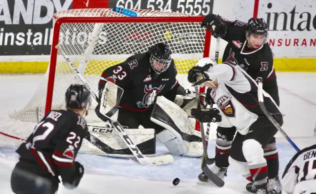 Vancouver Giants and Red Deer Rebels fight for a loose puck