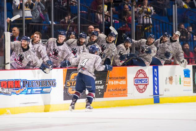 Forward Bobby Watson is congratulated by Tulsa Oilers teammates