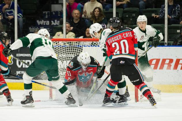 Kelowna Rockets Goaltender Brodan Salmond tires to fight off the Everett Silvertips