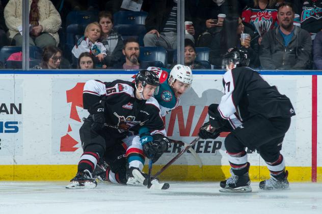 The Vancouver Giants battle the Kelowna Rockets for the puck