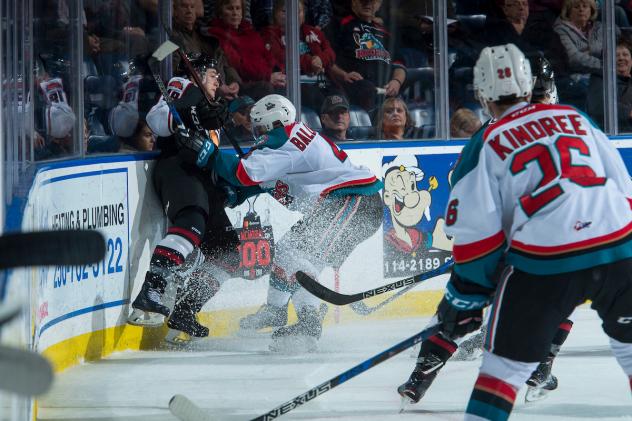 Kelowna Rockets Defenceman Gordie Ballhorn crushes and opponent while Liam Kindree looks on