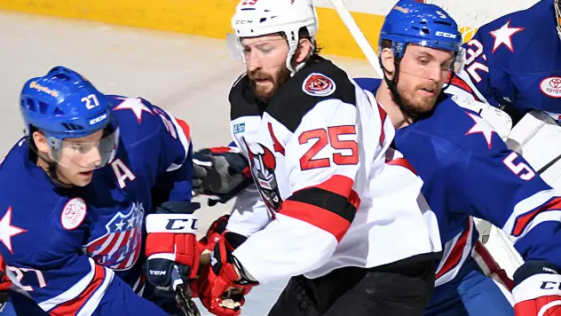 Binghamton Devils Right Wing Nick Lappin battles the Rochester Americans