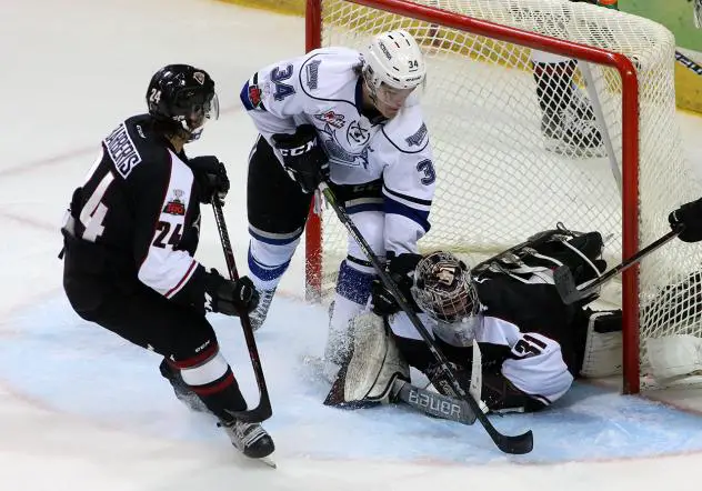 Vancouver Giants Goaltender Trent Miner covers a Victoria Royals's shot