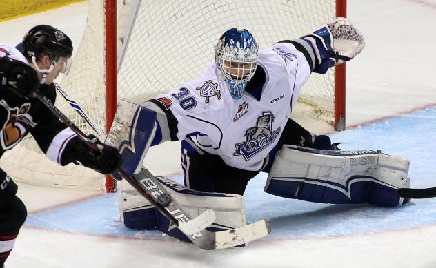 Victoria Royals Goaltender Griffen Outhouse stops a Vancouver Giants shot