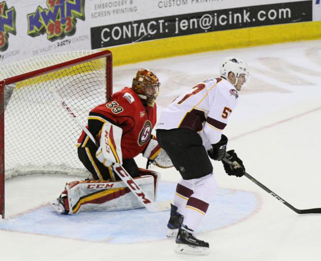 Cleveland Monsters Goaltender Matiss Kivlenieks holds off the Stockton Heat