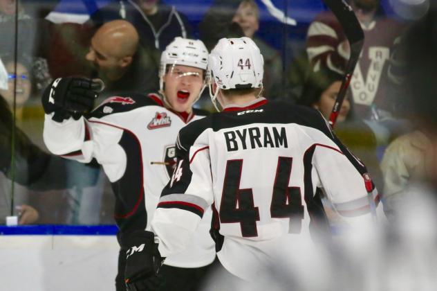 Dylan Plouffe and Bowen Byram of the Vancouver Giants celebrate Plouffe's goal