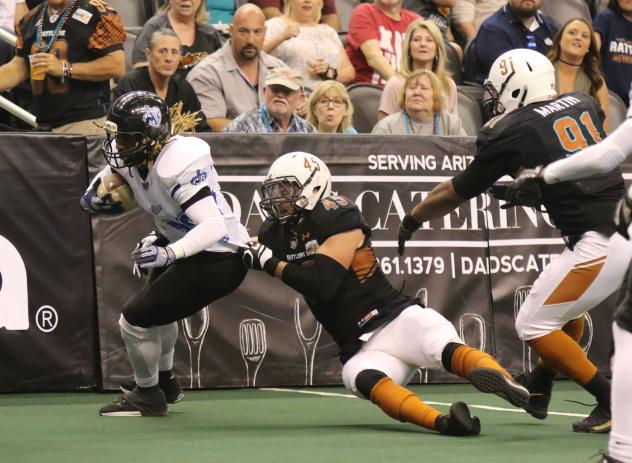 Ryan Langford of the Arizona Rattlers holds on to a Cedar Rapids Titans ballcarrier
