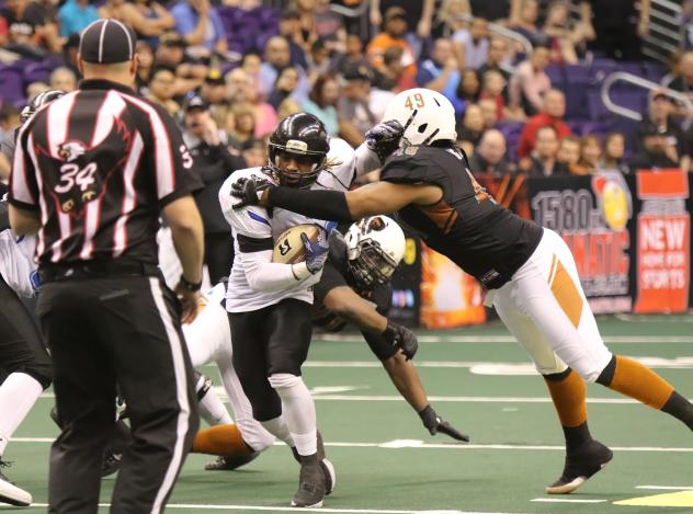 Edward Mosley of the Arizona Rattlers converges on a Cedar Rapids Titan