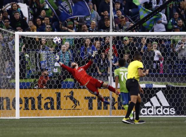 Seattle Sounders FC Goalkeeper Stefan Frei makes a diving save on a first-half Montreal Impact free kick