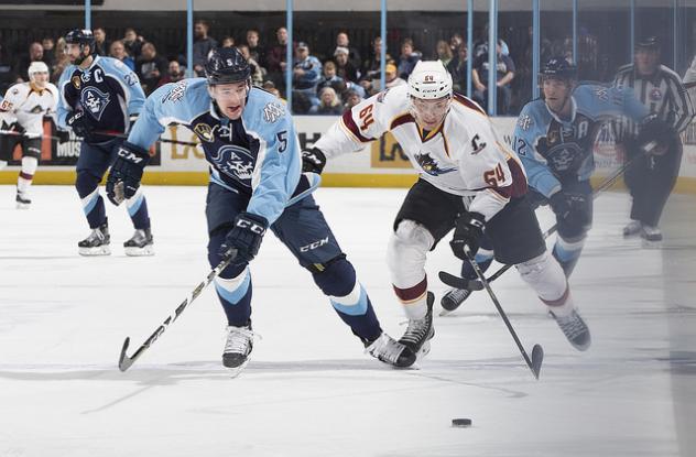 Milwaukee Admirals Defenseman Jack Dougherty and Cleveland Monsters Right Wing Phil Lane race for the puck