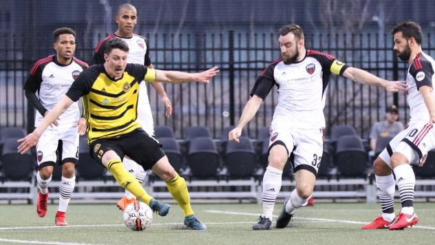 Ottawa Fury FC surround a Pittsburgh Riverhounds player