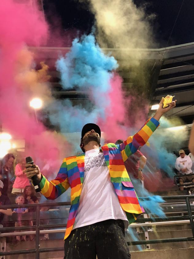 Charleston RiverDogs fans pelt the emcee with colored corn starch during Joseph P. Riley, Jr. and the Amazing Technicolor Ballpark Night