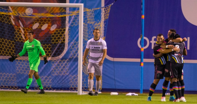 Las Vegas Lights FC's Sammy Ochoa (left) and Marco Cesar Jaime Jr. (center) celebrate Joel Huiqui's goal