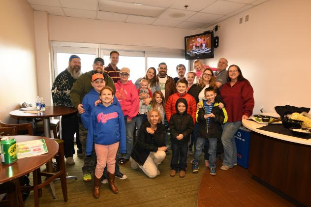 A group enjoying a Dragons game from a suite