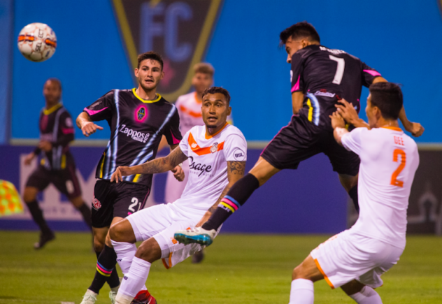 Las Vegas Lights FC's Carlos Alvarez (7) leaps for possession vs. Tulsa Roughnecks FC