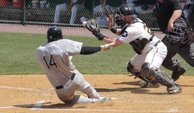 Robert Garcia of the Long Island Ducks beats the tag to complete his game-winning, inside-the-park home run