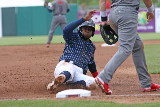 Irving Falu of the Syracuse Chiefs slides safely into third