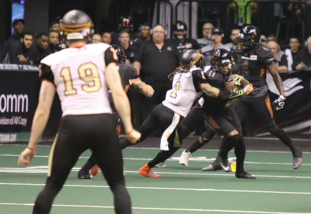 Arkeith Brown of the Arizona Rattlers tries to fight through the Iowa Barnstormers