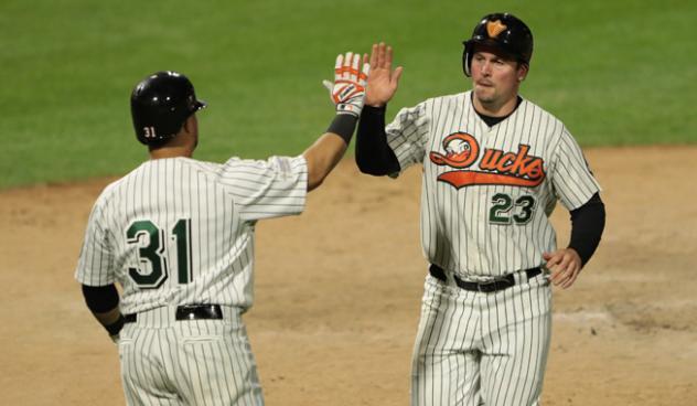 Ramon Cabrera and Travis Snider of the Long Island Ducks exchange high fives