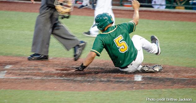 Sam Vega of the Normal CornBelters slides safely home