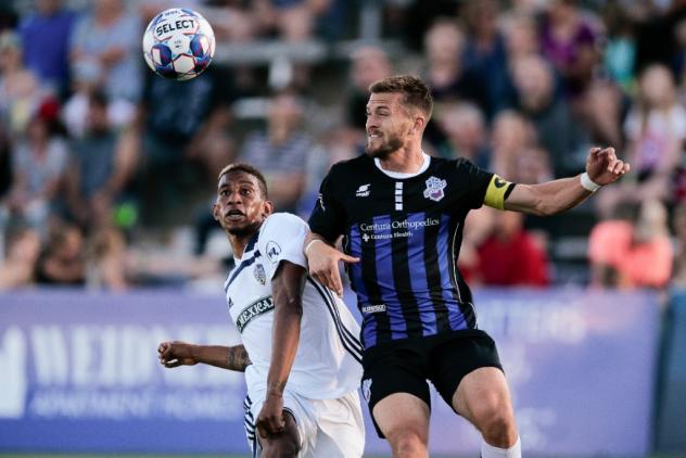 Colorado Springs Switchbacks battle for a ball against Fresno FC