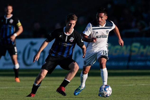 Colorado Springs Switchbacks jockey for the ball against Fresno FC