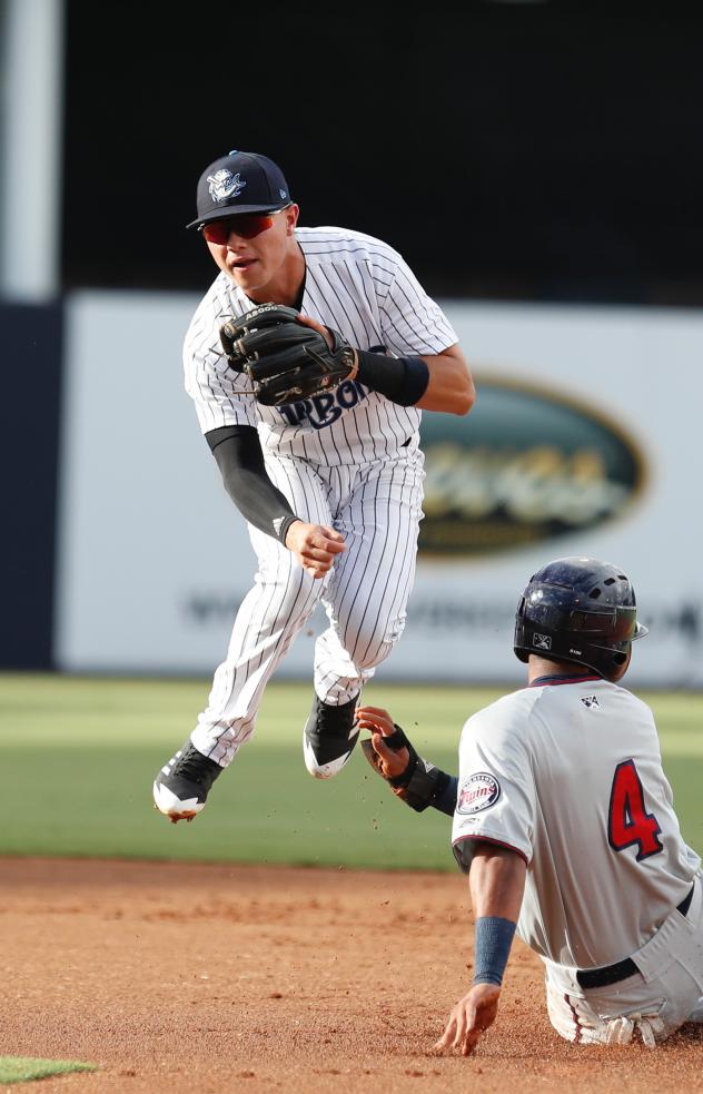 Diego Castillo of the Tampa Tarpons leaps into the air after making a throw