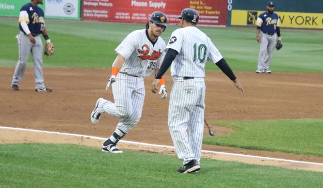Taylor Ard and Kevin Baez of the Long Island Ducks exchange a low five